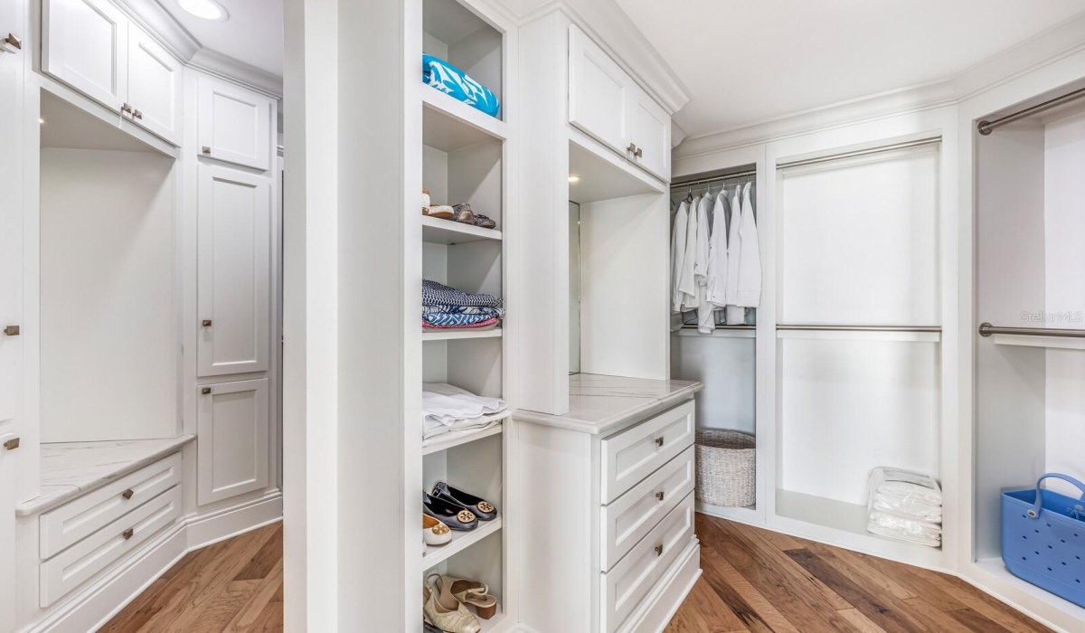 Generous walk in closet with custom built-ins