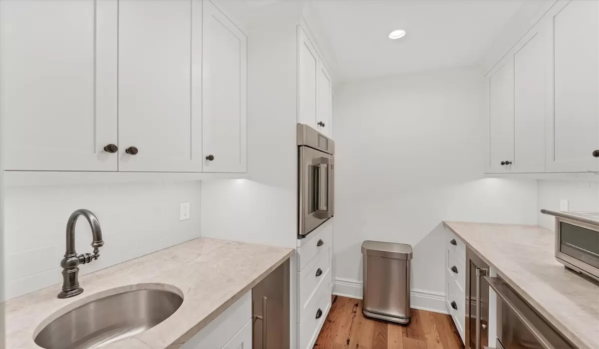 Butler's pantry: wet bar, Perlick wine refrigerator,Scotsman Ice-Maker, Cafe French Door Single Wall Oven, Monogram Beverage Drawers
