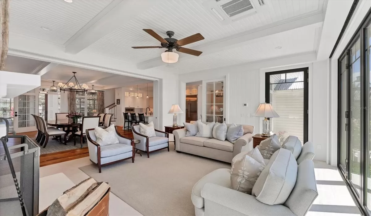 Living room with two additional exterior doors to access the outdoor kitchen, patio, and dock.