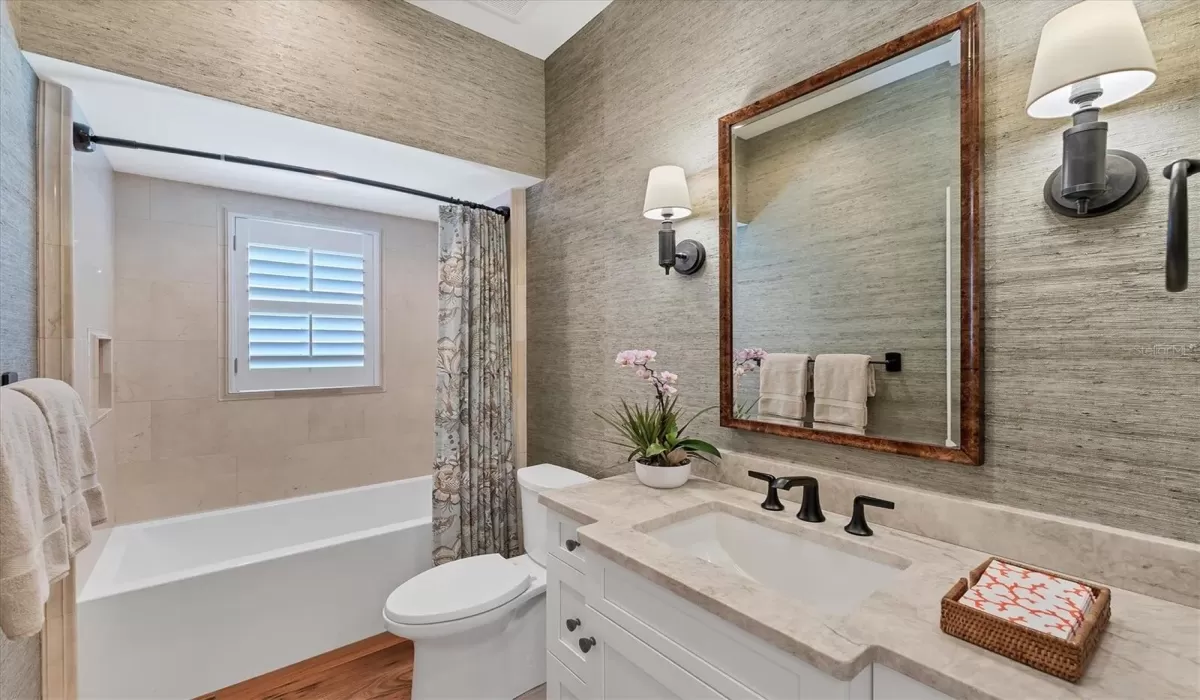 Full size powder bathroom with Jacuzzi tub adjacent to den.