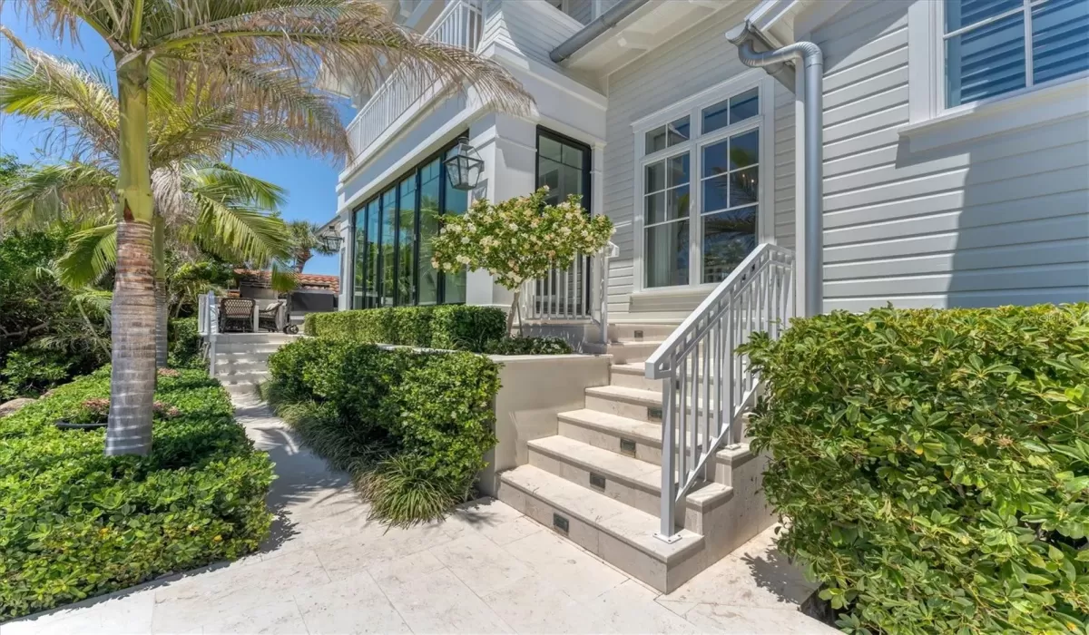 Rear access to the outdoor living space that features stunning outdoor Travertine stone