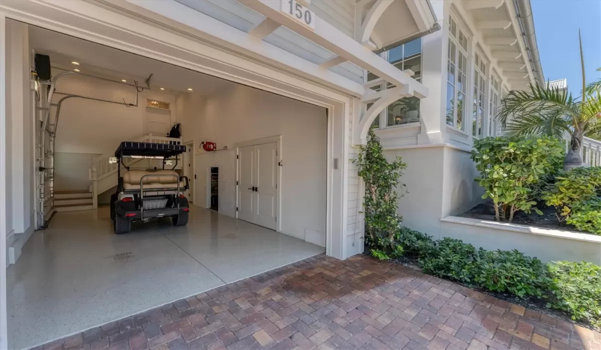 Single car extended garage that features two storage closets, one with a dehumidifier, side entry access for your golf cart, and elevator access to both the first and second floors.