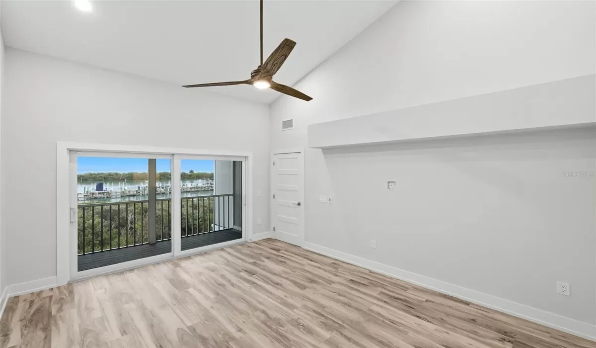 Primary Bedroom with screened lanai overlooking the marina